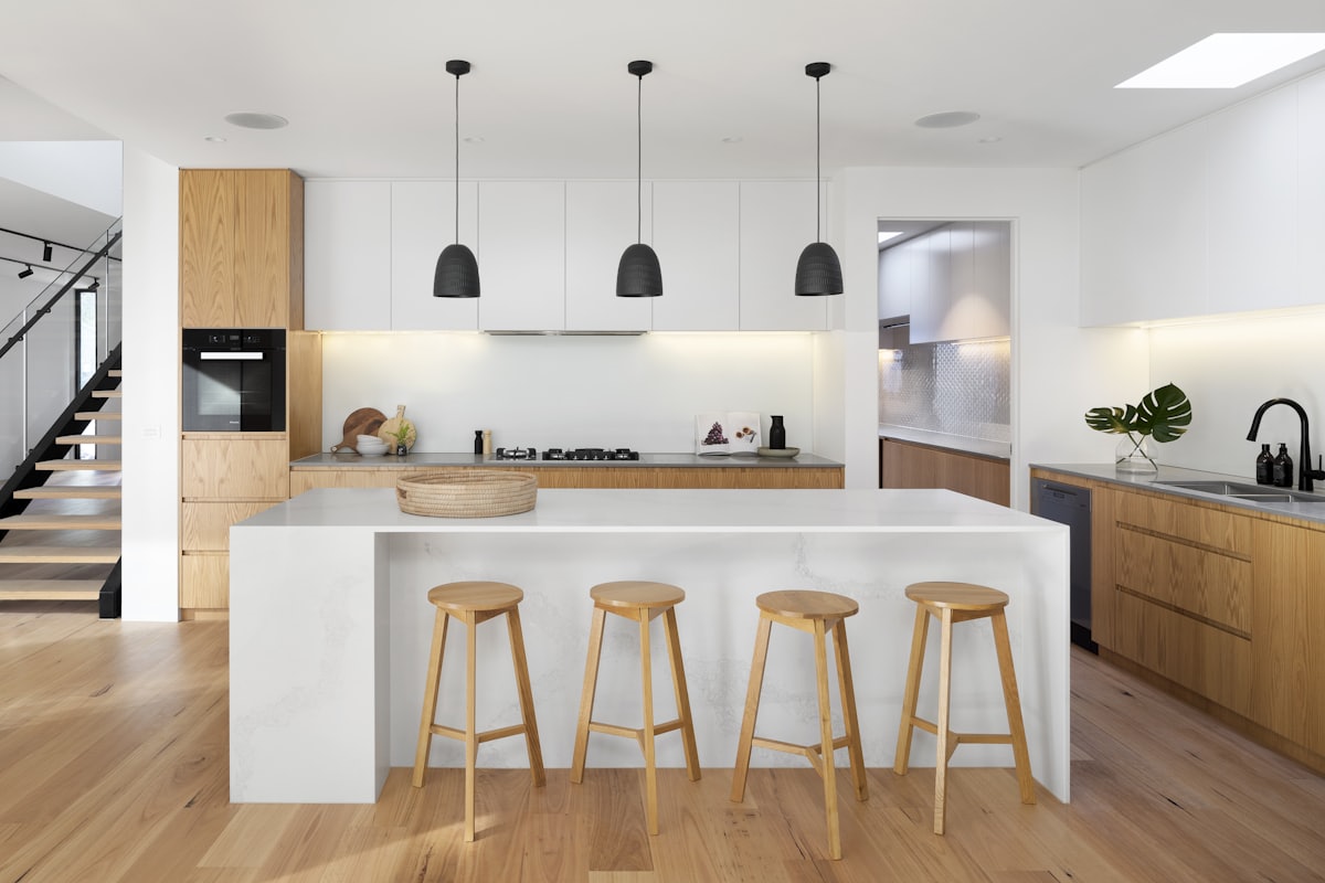 Modern kitchen with island bench and timber stools — fragile kitchen packing detail image